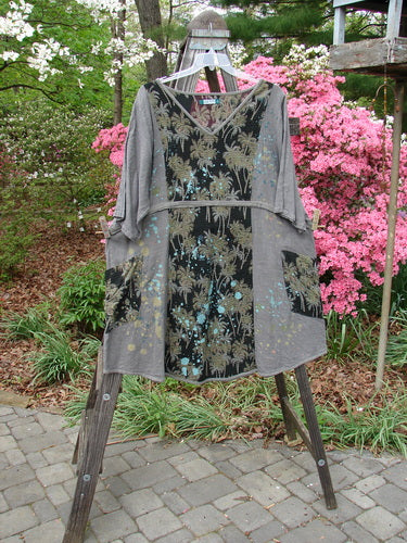 Barclay Linen Pucker Accent Urchin Dress Tropical Black Grey Size 2 on clothes rack, featuring tropical palm theme, deep V neckline, drop wrap pockets, A-line shape, and wide sleeves. Vintage Blue Fish Clothing from BlueFishFinder.com.