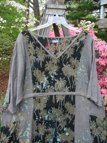 Barclay Linen Pucker Accent Urchin Dress featuring a playful tropical palm print on black and grey. Generously styled with deep V neckline, wrap pockets, A-line shape, and wide sleeves. Vintage Blue Fish Clothing at BlueFishFinder.com.
