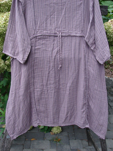 Barclay NWT Gauze Daily Pocket Dress Stripe Rose Earth Size 0: A lightweight, crinkled cotton dress with flared sleeves, tie-belt, and raw-edged seams, displayed outdoors on a hanger.