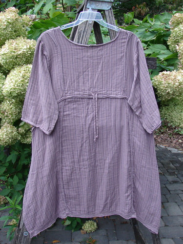 Barclay NWT Gauze Daily Pocket Dress Stripe Rose Earth Size 0, featuring a textured cotton fabric, elbow-length sleeves, empire waist with tie, asymmetrical hem, and vertical rolled seams. Hangs outdoors on a plastic hanger.
