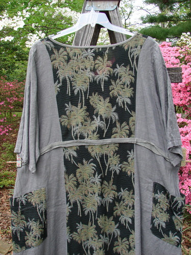 Barclay Linen Pucker Accent Urchin Dress Tropical Black Grey Size 2, a vintage Blue Fish creation by Jennifer Barclay. A grey shirt with palm trees, a playful tropical print, deep V neckline, drop wrap pockets, and wide sleeves.