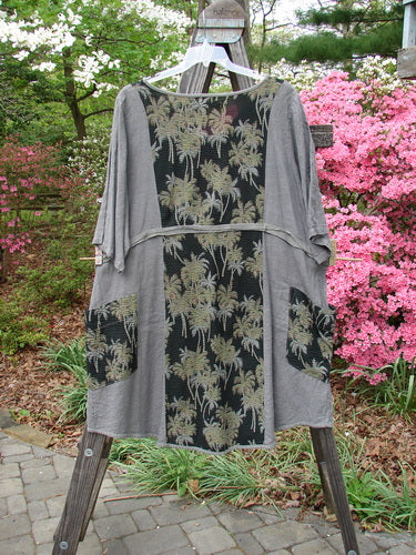 Barclay Linen Pucker Accent Urchin Dress featuring a playful tropical palm print on grey fabric. Generous A-line silhouette with deep V-neck, wrap pockets, and wide sleeves. Vintage Blue Fish Clothing from BlueFishFinder.com.