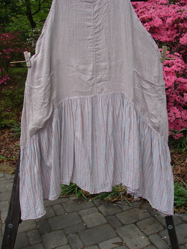 Barclay Gauze Batiste Peasant Jumper in Unpainted Stripe Mallow, Size 2, hanging on a clothesline outdoors. Features a cotton gauze upper and batiste stripe lower with wrap pockets. Vintage Blue Fish Clothing.