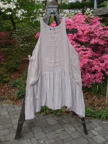Barclay Gauze Batiste Peasant Jumper in Unpainted Stripe Mallow, Size 2, hanging outdoors on a clothesline. Features a sweeping batiste lower, deep scoop neckline, varying hemline, and exterior wrap pockets.