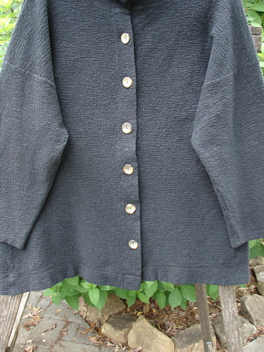 Barclay Crepe Mock Collar Jacket Unpainted Black Size 0 featuring a textured stretch crepe fabric, full button-up mock neckline, long wide sleeves, and drop shoulders for a classic, simplistic look.