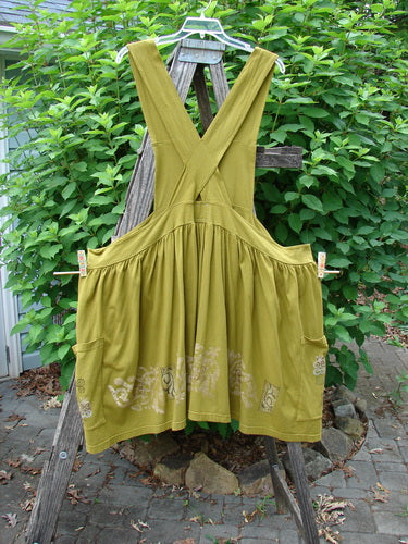 Barclay Overall Jumper Celtic Sun Glazed Tile OSFA features a creatively cut bib, longer length, full gathered skirt, oversized wrap pockets, and crisscross back straps, embodying vintage Blue Fish Clothing style.