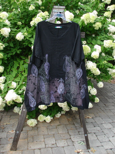 Barclay Linen Viscose Vented Urchin Dress with Fancy Paisley Black Stripe Size 2: A black shirt with purple designs on a rack, featuring white flowers and a close-up of a bush.