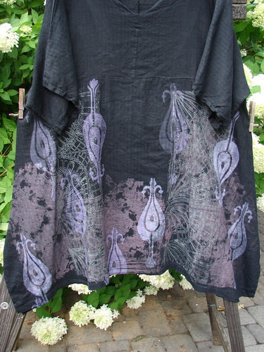 Barclay Linen Viscose Vented Urchin Dress with Fancy Paisley Black Stripe, Size 2. A black shirt with purple peacock feathers design, white flowers, and a unique pattern.