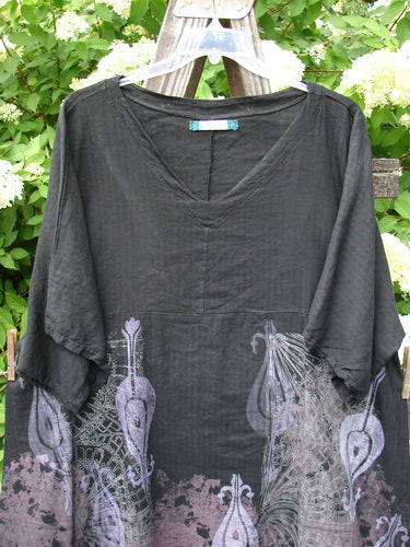 Barclay Linen Viscose Vented Urchin Dress: A black dress with purple peacocks and flowers, featuring a V-shaped neckline, three-quarter length sleeves, and vented sides. Size 2.