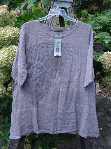 Barclay NWT Linen Simple Tunic Top features a loose-fitting, long-sleeve design with a slightly crinkled texture and faint graphic print. It's in Opal Mauve, with a rounded neckline and flowy A-line shape.
