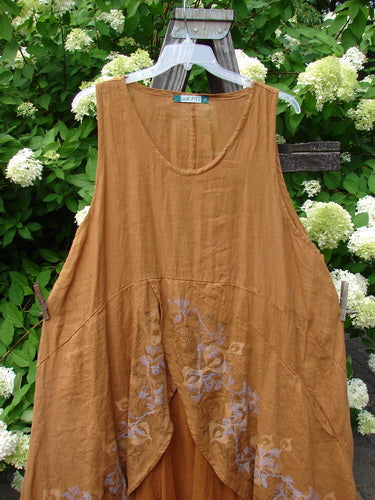 Image alt text: Barclay Linen Open Front Drawcord Hem Jumper Garden Squash Size 2 - A brown dress with a layered cross over front and elastic gathered hemline, featuring a moving garden theme.