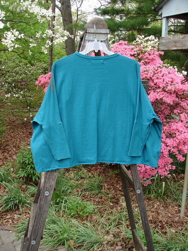 Barclay Crop Rib Sleeve Top displayed on wooden rack, featuring dolman sleeves, crop length, wide lower hem, ribbed sleeve accents, and rounded neckline. Vintage Blue Fish Clothing from BlueFishFinder.com.