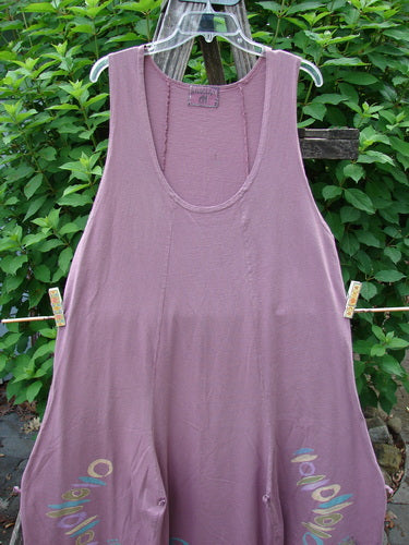 Barclay Constellation Jumper Music Festival Dusty Plum Size 1 displayed hanging, showcasing its deeply scooped neckline, pointed hemline accents, and vertical panels, embodying vintage Blue Fish Clothing's creative expression.