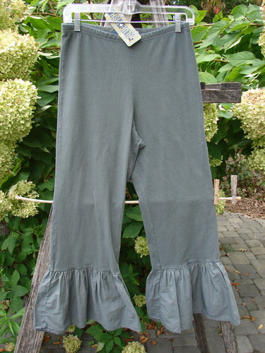 Barclay NWT Poplin Bottom Pantaloon Unpainted Chimera Size 0, featuring muted gray-green knit fabric, wide elastic waistband, straight legs, flared ruffled cuffs, and attached swing tag, hanging outdoors.