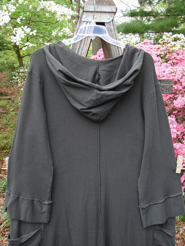 Vintage Barclay Thermal Cotton Lycra Hooded Circle Dress in Off Black, Size 2, hanging on a clothesline. Features a V neckline, floppy hood, circular drop pockets, A-line shape, and vertical seams. From BlueFishFinder.