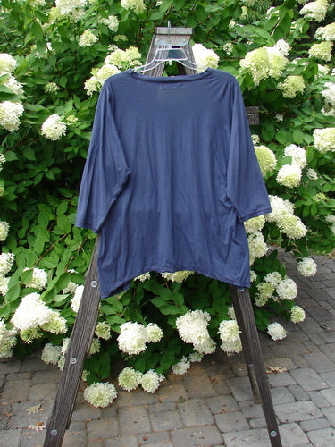 Image alt text: Barclay Tissue Raglan V Neck Layering Top in Navy Sky, Size 2, on a wooden rack.