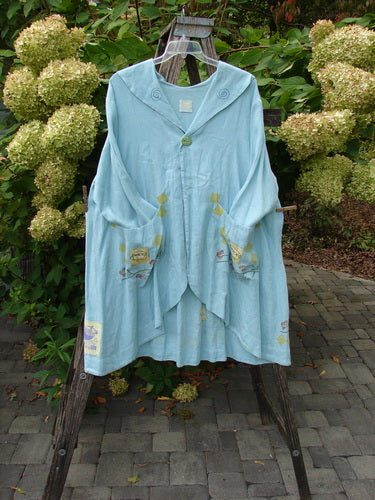 1999 Linen Breeze Jacket Tea & Cherries Spring OSFA featuring a pastel-blue, loose-fitting design with a wide sailor collar, long sleeves, and oversized front pockets, showcasing cherry and teatime motifs.