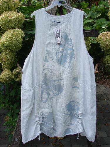 Barclay NWT Linen Image Pinafore Pocket Overpiece Floral Burst Dew Size 0 features a loose-fitting, sleeveless design with floral patterns, rounded neckline, deeper arm openings, side pockets, and drawstrings, hanging outdoors.