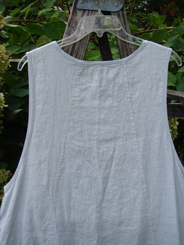 Barclay NWT Linen Image Pinafore Pocket Overpiece Floral Burst Dew Size 0 hanging outdoors, highlighting vertical seams, deeper arm openings, and dual exterior pockets against garden greenery.