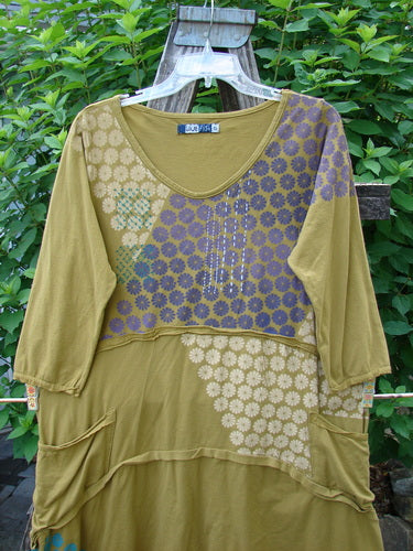 Barclay Raw Seam Vector Tunic Dress, featuring purple and blue floral patterns, showcases raw edges, a varying hemline, and fluttery sleeve edges, embodying BlueFishFinder's vintage and creative style.