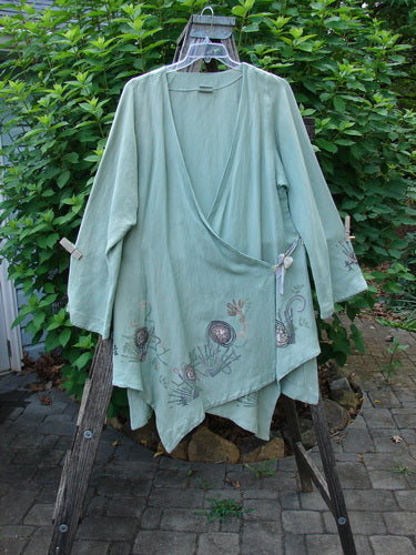 Barclay Viscose Long Ribbon Side Tie Jacket Garden Folly Kelp Size 0, featuring a single thicker ribbon drop closure and a varying painted hemline, showcasing unique textures and artistic design elements.