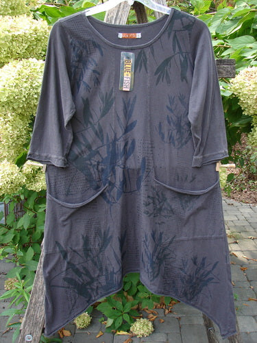 Barclay NWT Sunny Day Pocket Tunic Dress Flutter Bamboo Steel Meteorite Size 1, featuring three-quarter sleeves, asymmetric hem, patch pockets, and leaf print on medium-weight organic cotton, hanging outdoors.