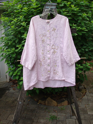 Barclay Linen Shell Button Drawcord Cardigan Butterfly Orchid Size 0 features a flowy design with shell buttons, a drawcord backline, and a butterfly garden theme, highlighting its unique hemline and neckline.