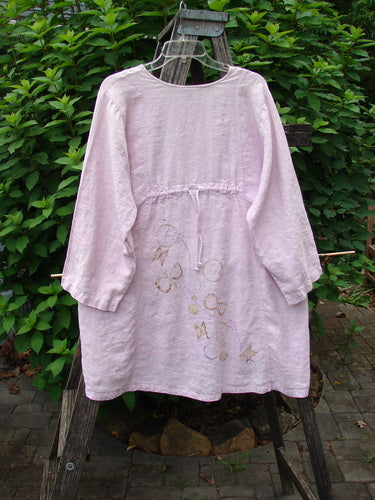 Barclay Linen Shell Button Drawcord Cardigan Butterfly Orchid Size 0, showcasing a flowy design with shell buttons, a varying hemline, and butterfly garden theme paint, emphasizing its detailed craftsmanship.