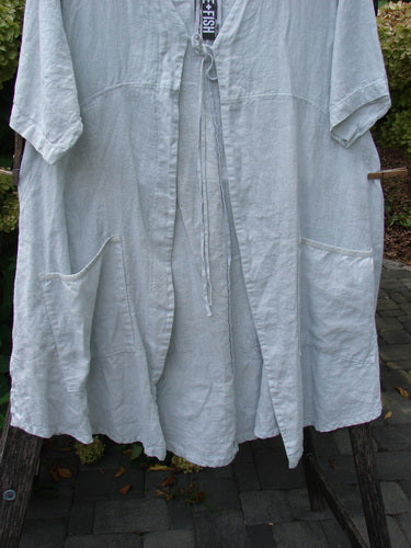 Barclay NWT Linen Contrast Tie Pocket Cardigan Field Twig Dew Size 0, featuring a loose, knee-length smock-style with short sleeves, two large front pockets, and a simple tie closure at neckline.