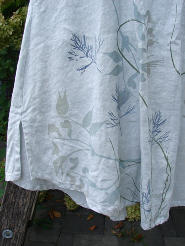 Barclay NWT Linen Contrast Tie Pocket Cardigan, size 0, draped on a bench. The silvery fabric features botanical motifs and a side slit, reflecting Bluefishfinder.com's vintage style.