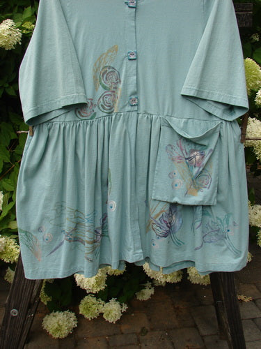 Barclay Flower Garden Tunic Dress Dragonfly Aloe Size 2: A blue shirt dress with a pattern, ceramic buttons, pleated skirt, and a painted pocket.