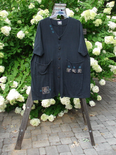 2000 Double Decker Pocket Top with forest flower design, black color. Made from organic cotton. Features oversized front pockets stacked on top of each other, pleated backline, and swing movement. Bust 68, waist 60, hips 64, sweep 80, length 35.