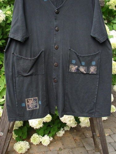 2000 Double Decker Pocket Top Forest Flower Black Size 2: A black shirt with oversized pockets stacked on top of each other. Features pleated back line and signature Blue Fish patch.