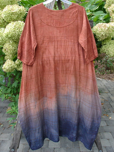 Barclay NWT Flannel Cross Over Blue Moon Pocket Dress Terra Ombre Plaid Size 0, displayed outdoors on a bench, features a mid-length, loose fit with an ombré plaid pattern.