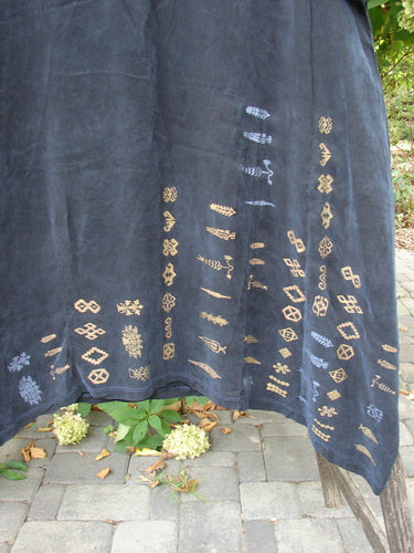 Barclay NWT Cupro Cross Over Urchin Dress displayed outdoors, draped over a wooden rail, showcasing its luxurious, silken texture and primitive metallic motifs, reflecting BlueFishFinder's vintage, creative fashion ethos.