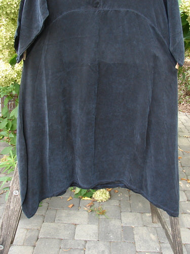 Barclay NWT Cupro Cross Over Urchin Dress draped over a wooden bench, showcasing its luxurious, lightweight velvet-like fabric and elegant design, aligned with Bluefishfinder.com's vintage clothing ethos.