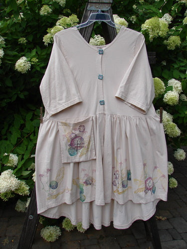 Barclay Flower Garden Cardigan Dress with a white floral design on a swinger.