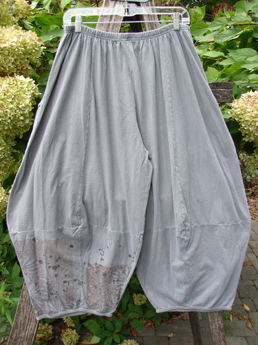 Barclay Crop Two Pocket 4 Square Pant Spin Flower Grey Green Size 0, featuring loose-fitting, drop-crotch design with sectional panels and double front drop pockets, displayed against lush green foliage and hydrangea backdrop.