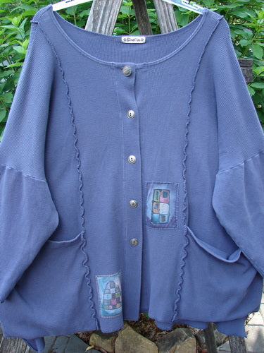Barclay Patched Thermal Curl Pocket Cardigan Geos Royal Orchid Size 3 features a patchwork design, full button front, dolman sleeves, two exterior pockets, and a slightly shirttail hemline.