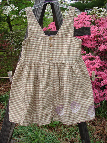 Vintage 1996 Woven Roadside Jumper with Flower Wheel motif in White Pine Gingham, Size 1. Features wooden buttons, pleated lower, squared neckline, and empire waist seam. Perfect for creative self-expression.