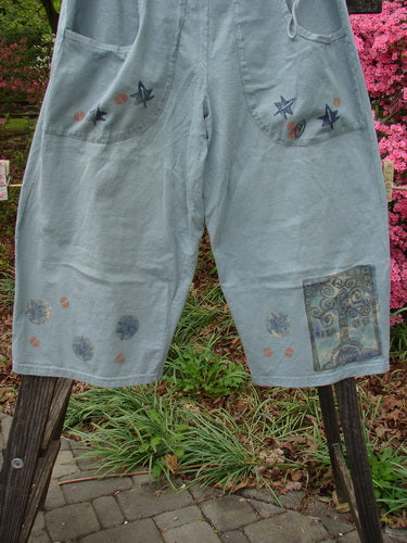 Vintage 1993 Garden Pant with Star Leaf Tree patches in Ocean, Size 2. Medium Weight Cotton. Corded Side Ties, Crop Wide Shape, Deep Pockets, Tree and Leaf Paint. Waist 26-58, Hips 58, Inseam 21, Length 35.