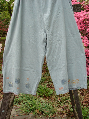 Vintage 1993 Garden Pant featuring a tree and leaf theme, corded side ties, and deep bushel pockets. Made of medium weight cotton in Ocean. Waist 26-58, Hips 58, Inseam 21, Total Length 35.