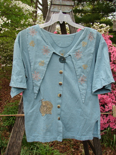 Vintage 1994 Compass Top featuring a Garden Bee design on a blue shirt. Perfect Condition, Cotton fabric. Unique pointed collar, original buttons, sweet side vents. Size 1: Bust 42, Waist 44, Hips 44, Length 26.