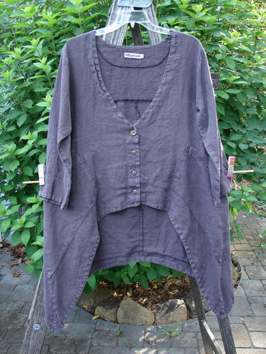 Barclay Hemp Cotton Summercloth Dip Side Pocket Jacket showcasing a V-shaped neckline, three-quarter banded sleeves, dual angular pockets, and pinwheel paint theme, hanging on a clothesline.