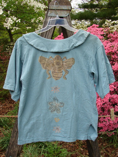 Vintage 1994 Compass Top featuring a Garden Bee design on a blue shirt. Detailed with a big pointed collar, original buttons, and sweet side vents. Size 1 in Dusk color. From BlueFishFinder.com.