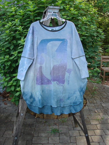Barclay NWT Thermal Contrast Revival Top Love Dove Blue Skies OSFA displayed outdoors, showcasing its ribbed sleeves, rounded neckline, and unique love dove theme, exemplifying Bluefishfinder.com's creative, vintage style.