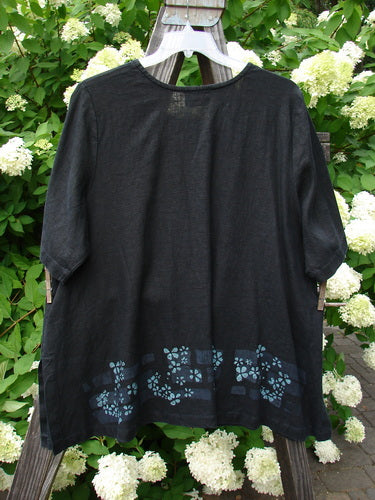 2000 T Top Floating Florals Black Size 2: Swing top with black shirt featuring blue flowers. A-line shape, side vents. Made from heavy weight linen.