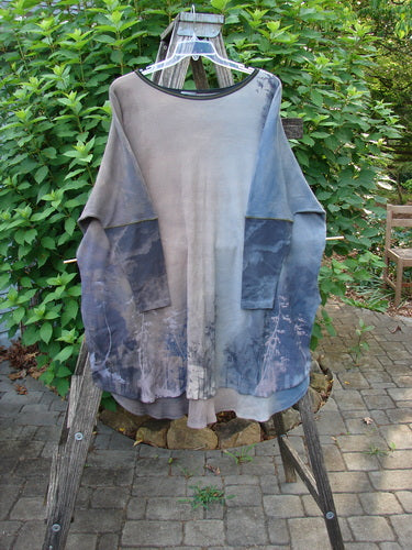 Barclay NWT Thermal Contrast Revival Top Tunic Tree Line Amethyst Smoke OSFA displayed on a clothes rack, highlighting its unique ribbed neckline and sleeves with a continuous tree line theme.