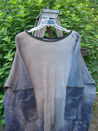 Barclay NWT Thermal Contrast Revival Top Tunic Tree Line Amethyst Smoke OSFA displayed on a swing hanger, showcasing ribbed sleeves, rounded neckline, and unique tree line theme, highlighting its generous cut and style.