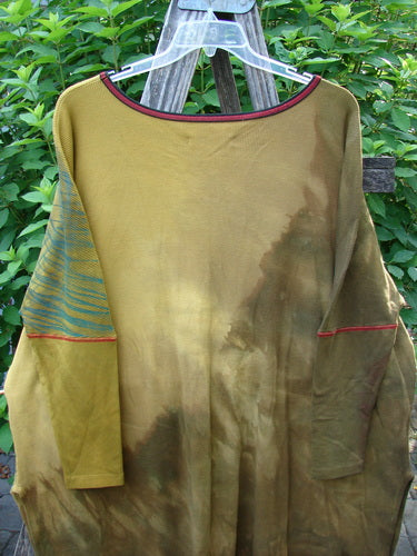 Barclay Thermal Contrast Revival Top Tulip Bronze OSFA displayed on a hanger, showcasing its contrasting ribbed sleeves, rounded neckline, and tulip theme paint, emphasizing its unique A-line shape and side vents.